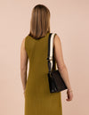 Model image with a black leather bag and an black and white cotton strap