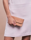Pixie Pouch Camel Hunter Leather. Rectangular shaped fold over wallet. Model image.