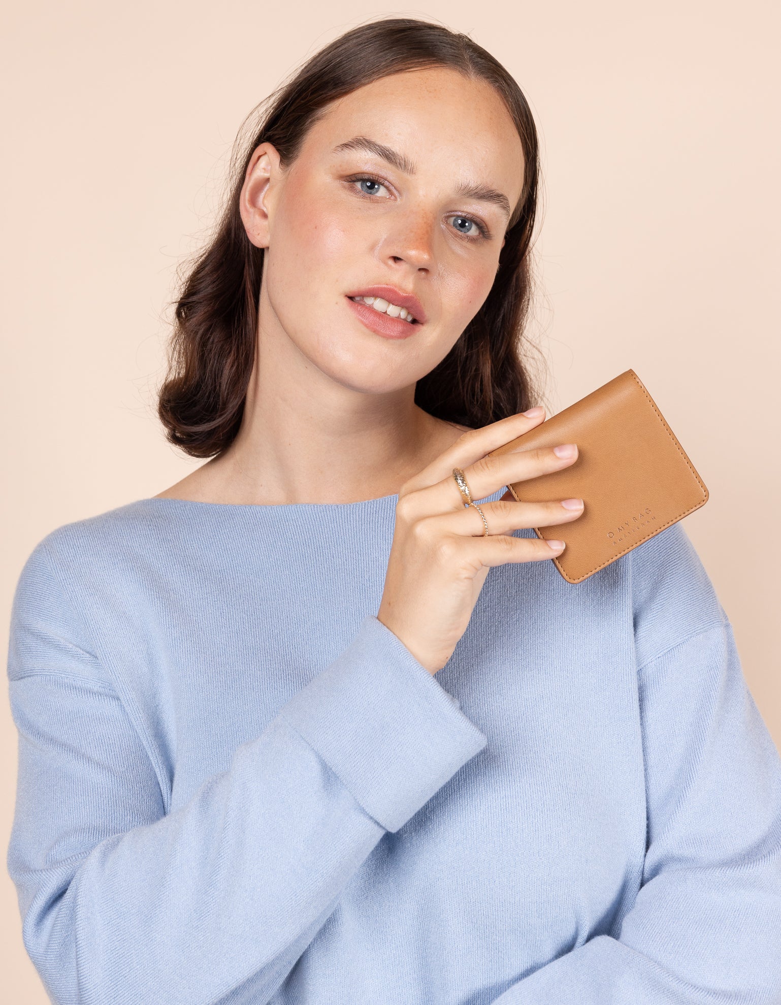Alex fold over wallet in cognac apple leather - model holding it
