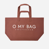 A Cocoa brown canvas tote bag with white printed text reading 'O MY BAG AMSTERDAM' on the front, set against a plain light gray background.