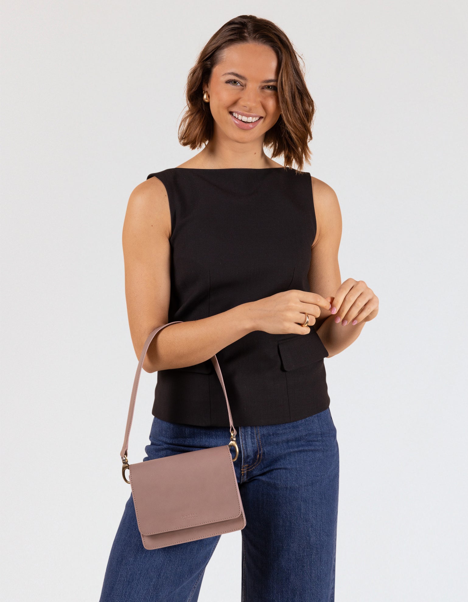 Model wearing Audrey Mini bag in mauve