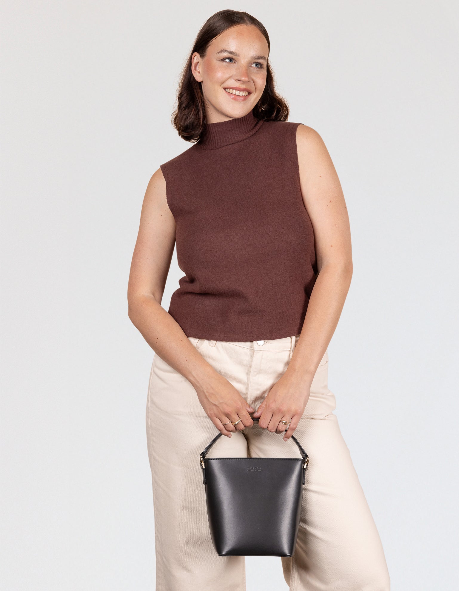 Female model holding bag in front