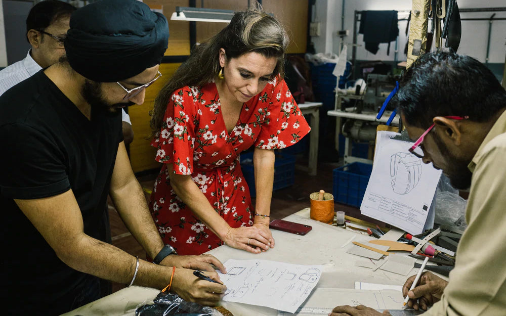Working on bag designs with the production team in India.