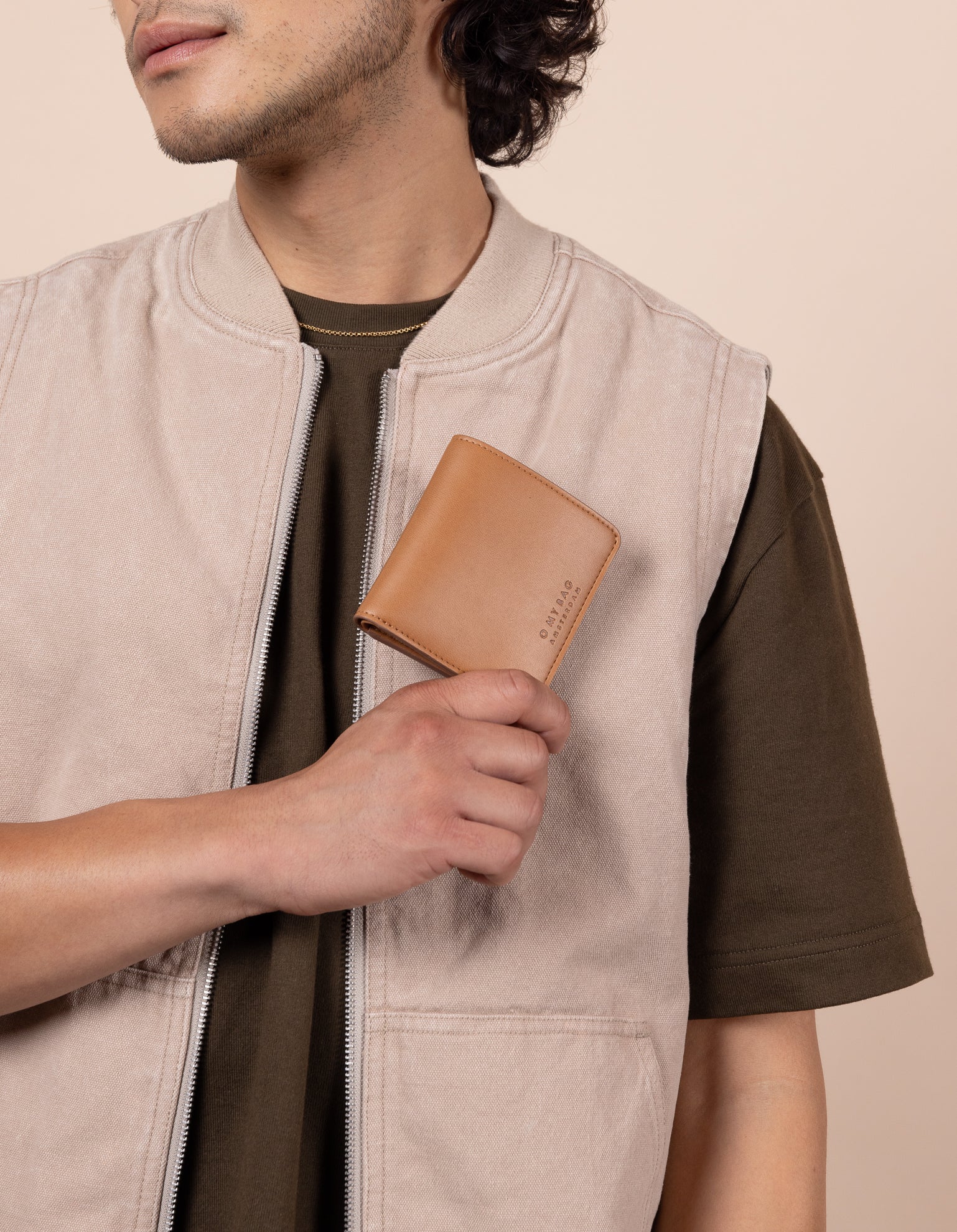 Alex fold over wallet in cognac apple leather - male model image