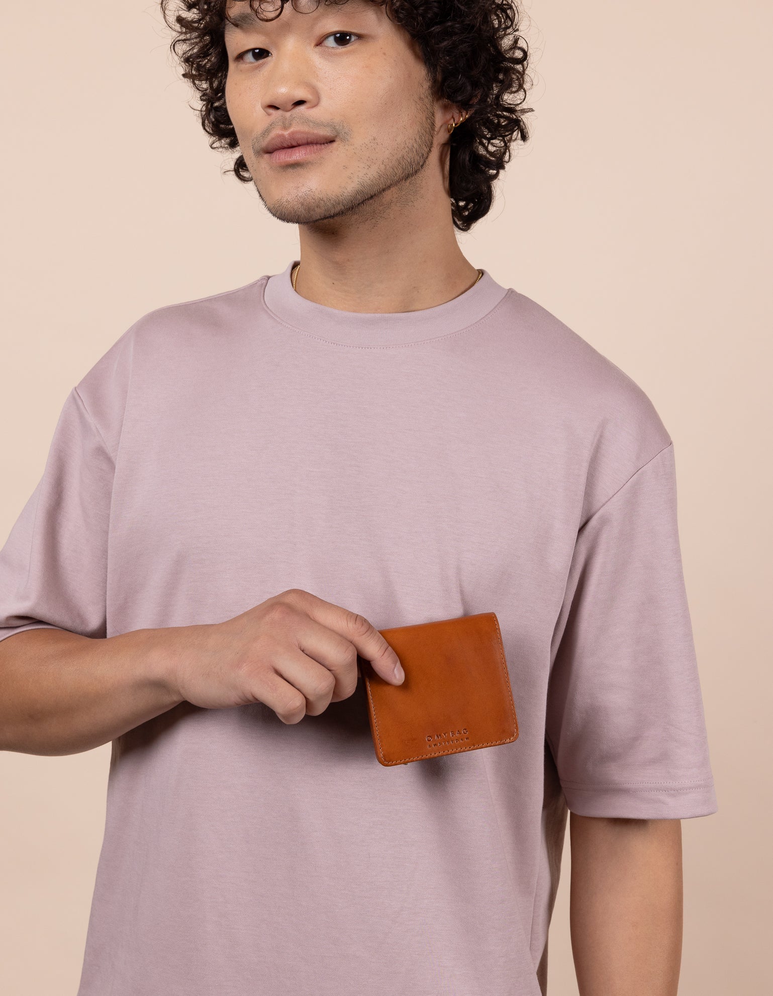 Alex's Fold-over Wallet Classic Leather cognac colour. Medium size, square shaped wallet, model image