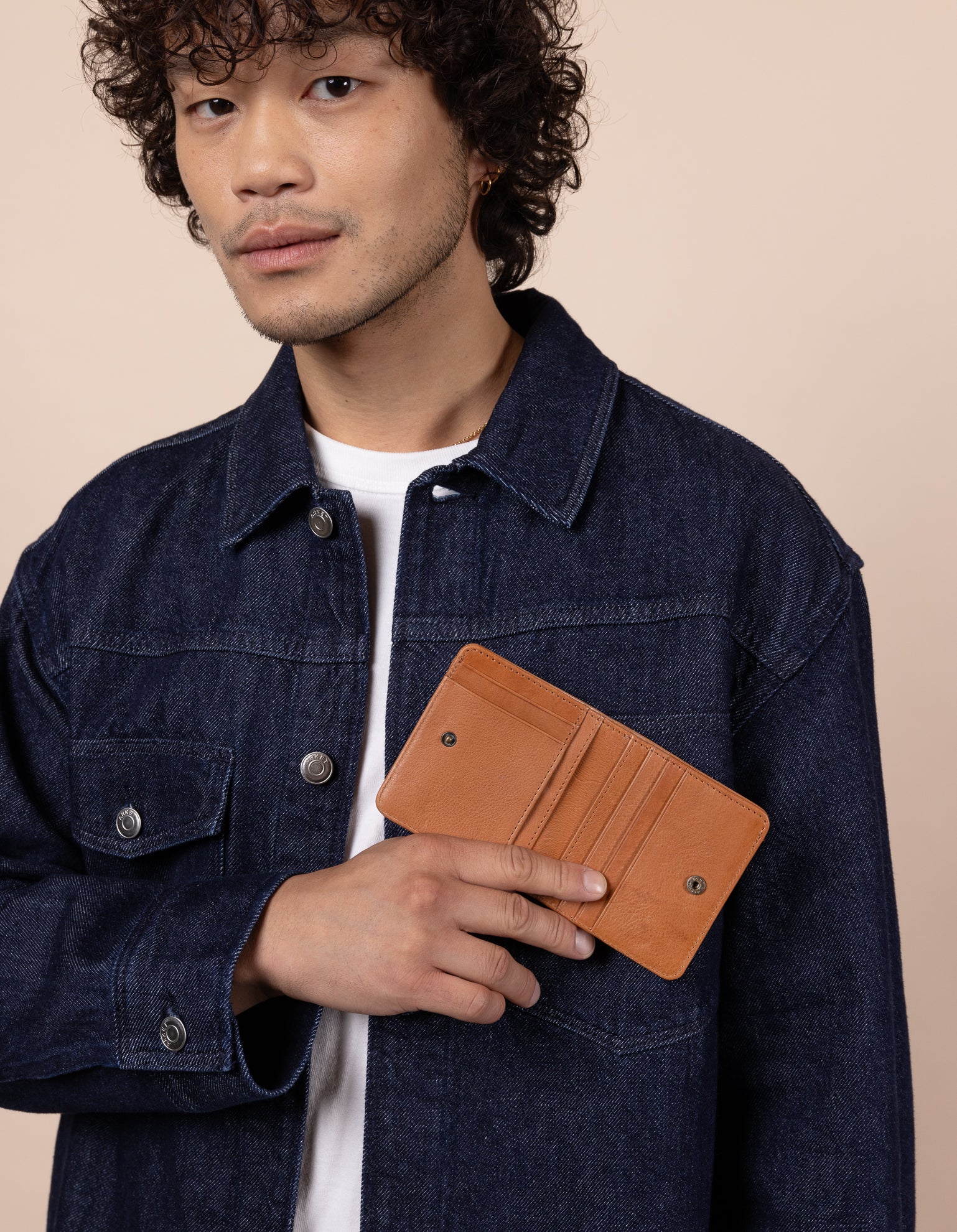 Alex fold over wallet in wild oak soft grain leather. Male Model product image.