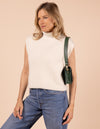 Model image showcasing Audrey Mini pine green classic leather crossbody bag with shoulder leather strap