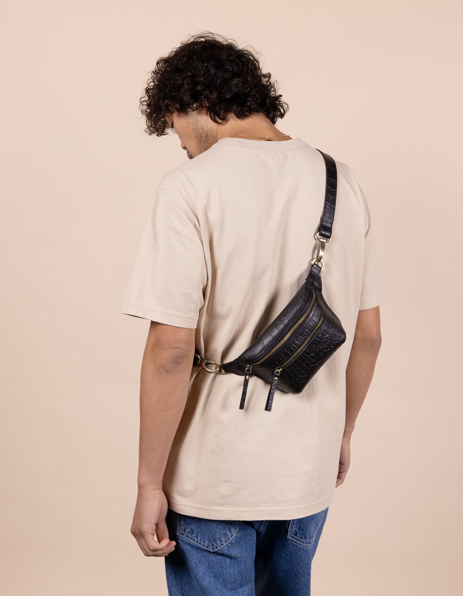 Becks Bum Bag in Black Croco Leather - male model product image. Back view