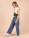 Model image showcasing Beck's Bum Bag pine green classic leather fanny pack with adjustable leather strap