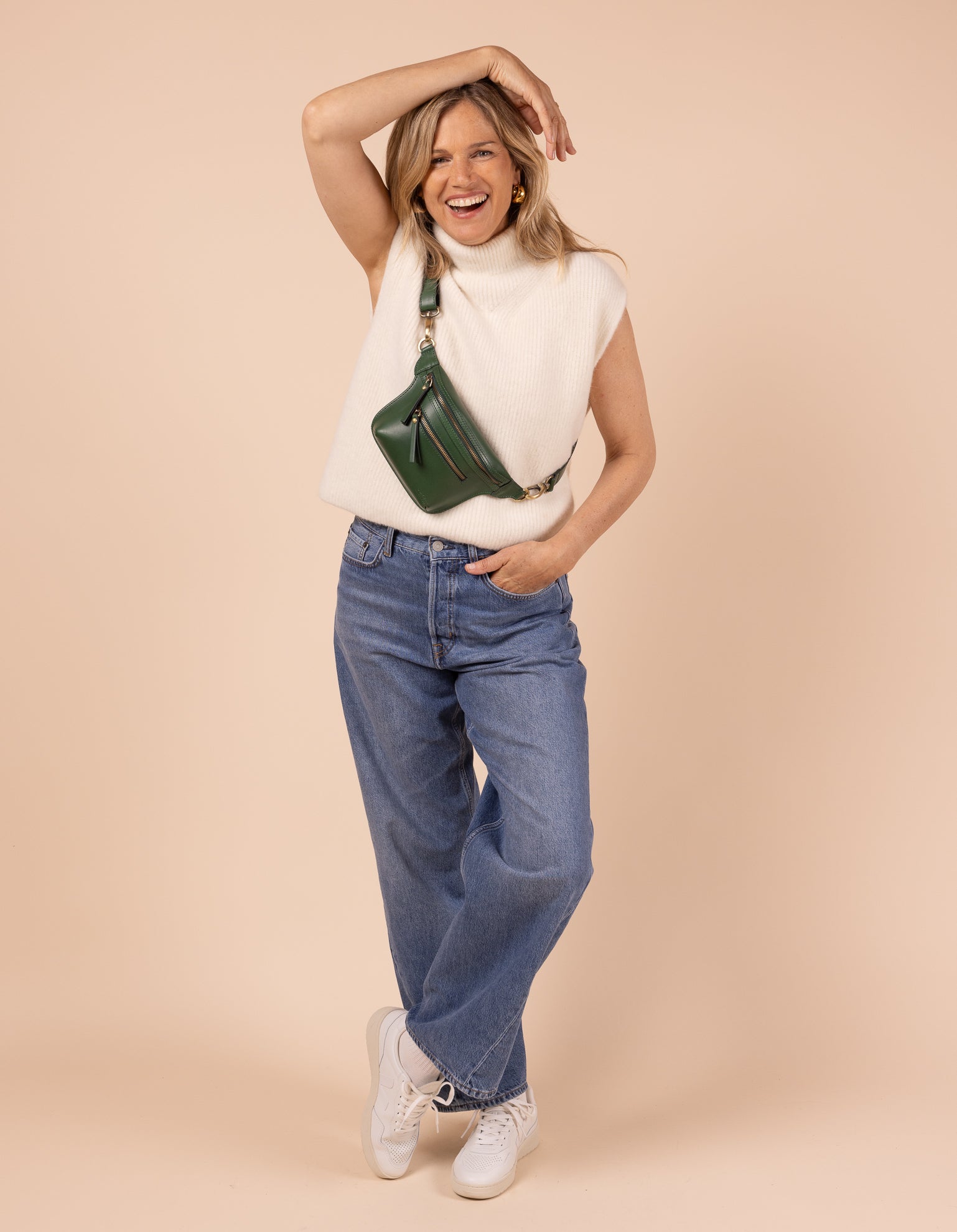 Model image showcasing Beck's Bum Bag pine green classic leather fanny pack with adjustable leather strap