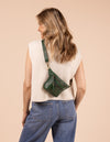 Model image showcasing Beck's Bum Bag pine green classic leather fanny pack with adjustable leather strap