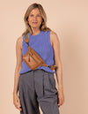 Model image of Beck's Bum Bag cognac vegan Uppeal fanny pack with adjustable checkered webbing strap