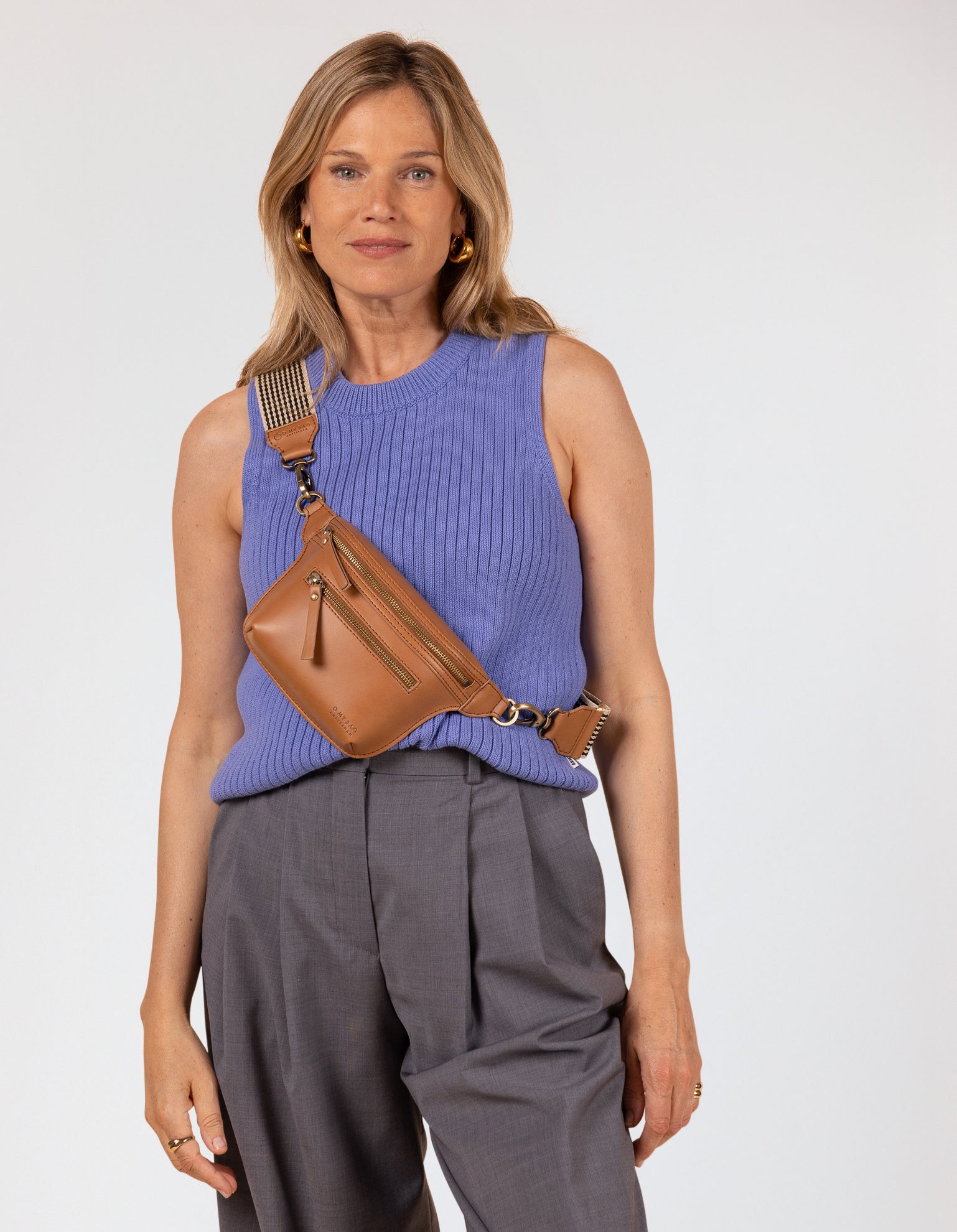 Model image of Beck's Bum Bag cognac vegan Uppeal fanny pack with adjustable checkered webbing strap