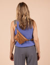 Model image of Beck's Bum Bag cognac vegan Uppeal fanny pack with adjustable checkered webbing strap