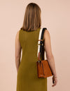 Model image with a brown leather bag and an black and white cotton strap