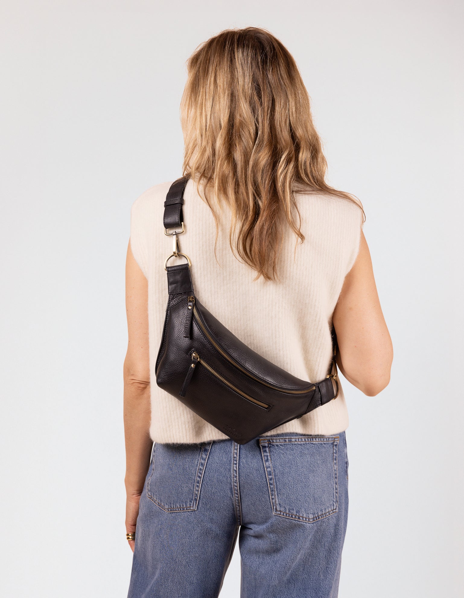 Model image of Drew Bum Bag black soft grain leather fanny pack with adjustable checkered webbing strap