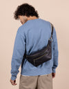  Drew Bum Bag in black soft grain leather - male model image with webbing strap