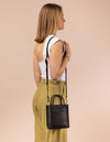 Rectangle shaped mini leather bag with thin shoulder strap- model image