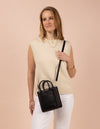 Rectangle shaped mini leather bag with thin cross-body strap- model image