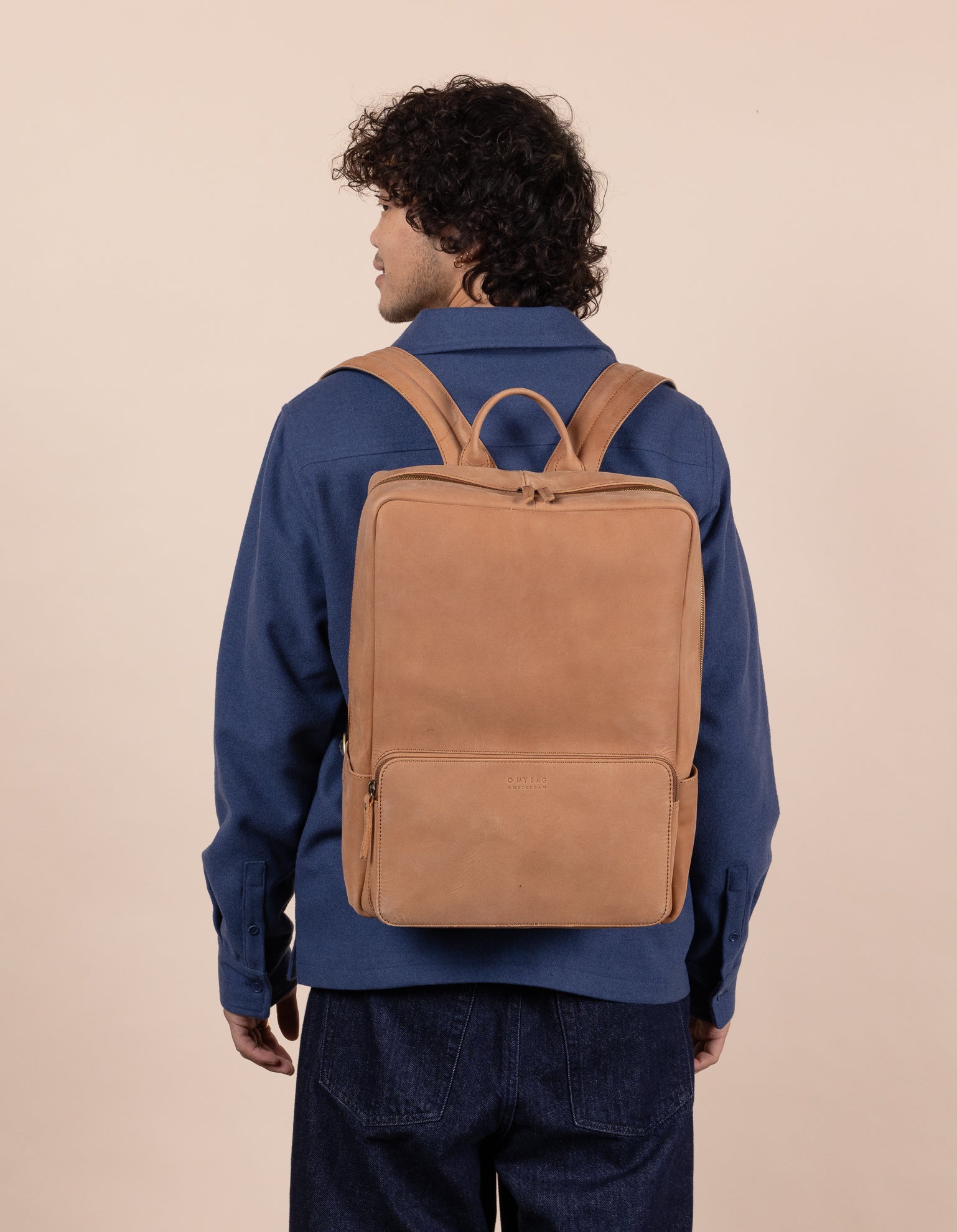 Camel Leather backpack. Model product image.