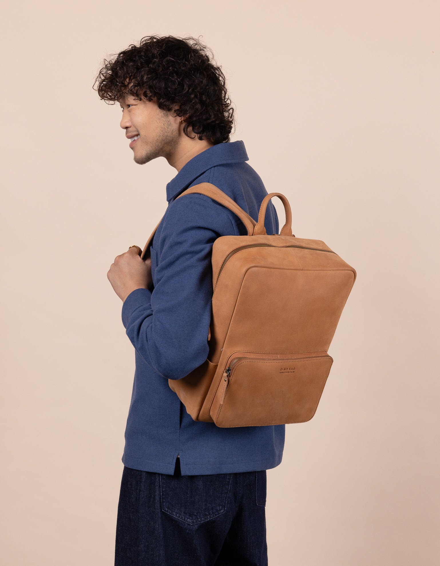 Camel Leather backpack. Model product image.