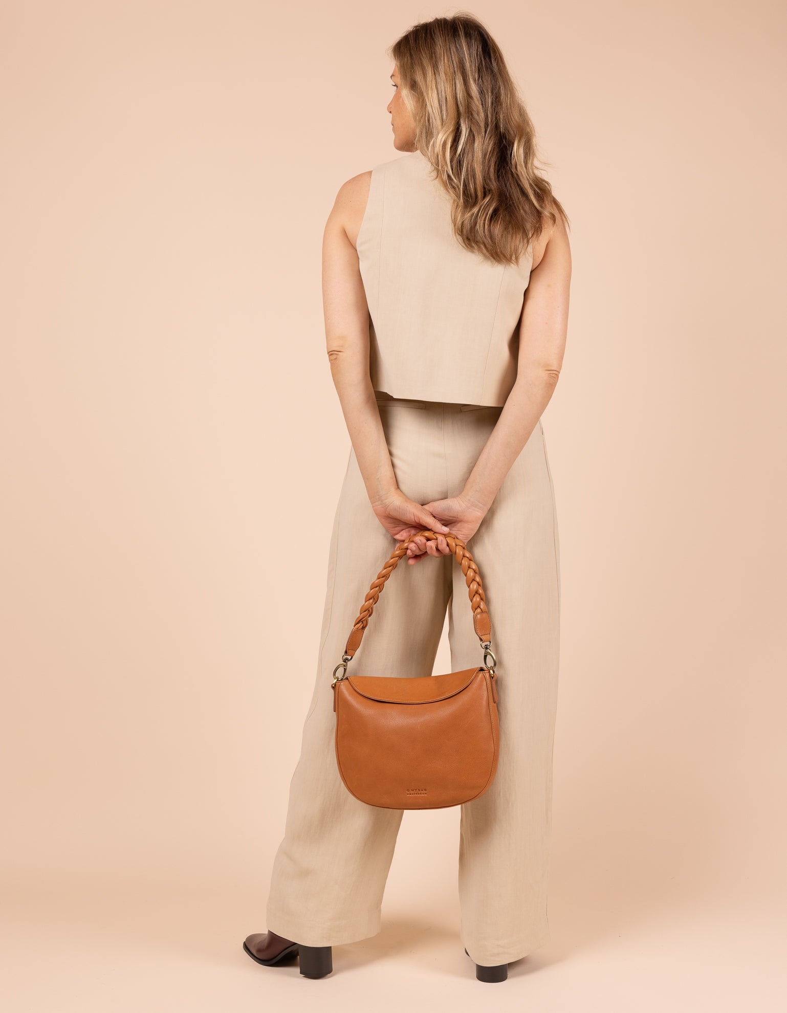 Model image showcasing Lana wild oak soft grain leather crossbody bag with braided shoulder strap