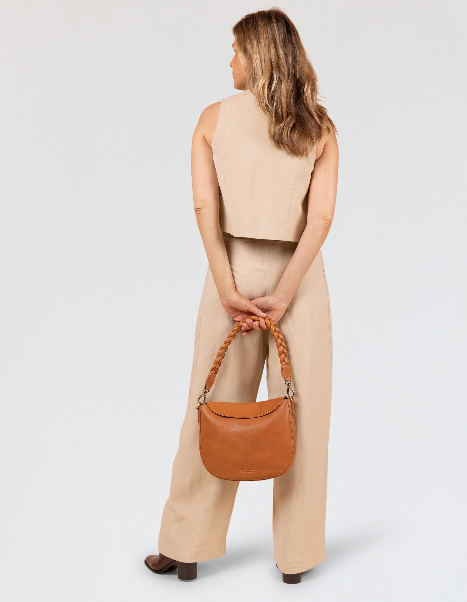 Model image showcasing Lana wild oak soft grain leather crossbody bag with braided shoulder strap