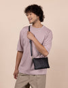Male Model with Lexi bag in black woven classic leather