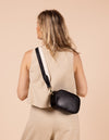 Model image showcasing Maya black classic leather crossbody bag with adjustable leather strap