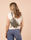 Model image showcasing Milo sage Mirum bum bag 