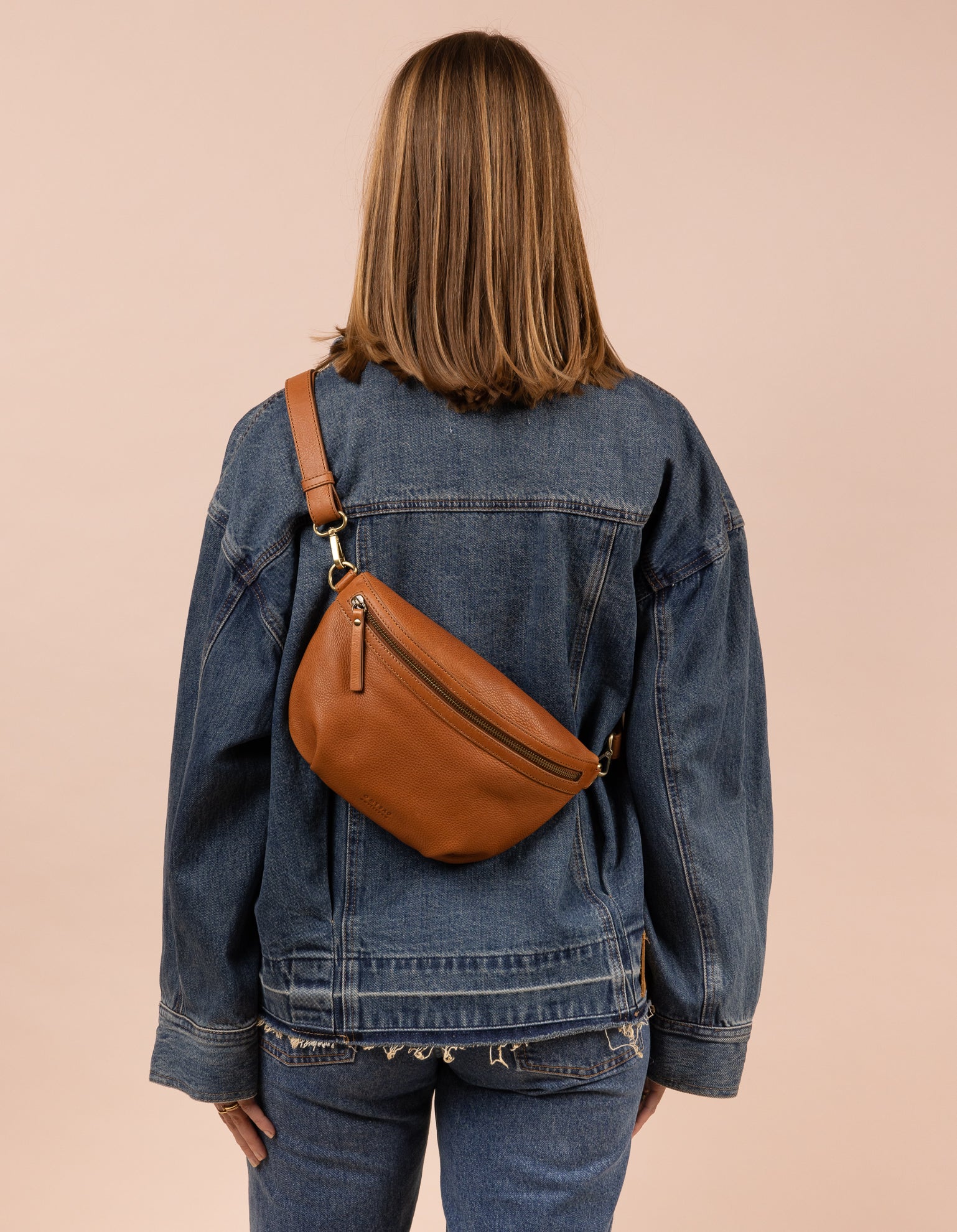 Brown soft leather bum bag worn cross-body on a model