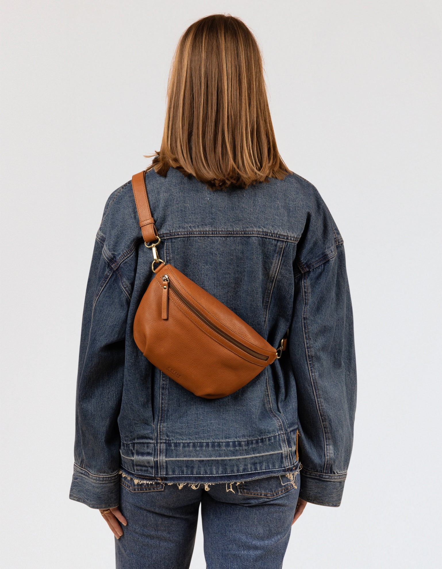 Brown soft leather bum bag worn cross-body on a model