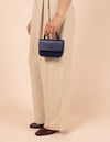 Model image showcasing Audrey Mini midnight blue classic leather crossbody bag