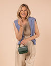 Model image showcasing Audrey Mini pine green classic leather crossbody bag