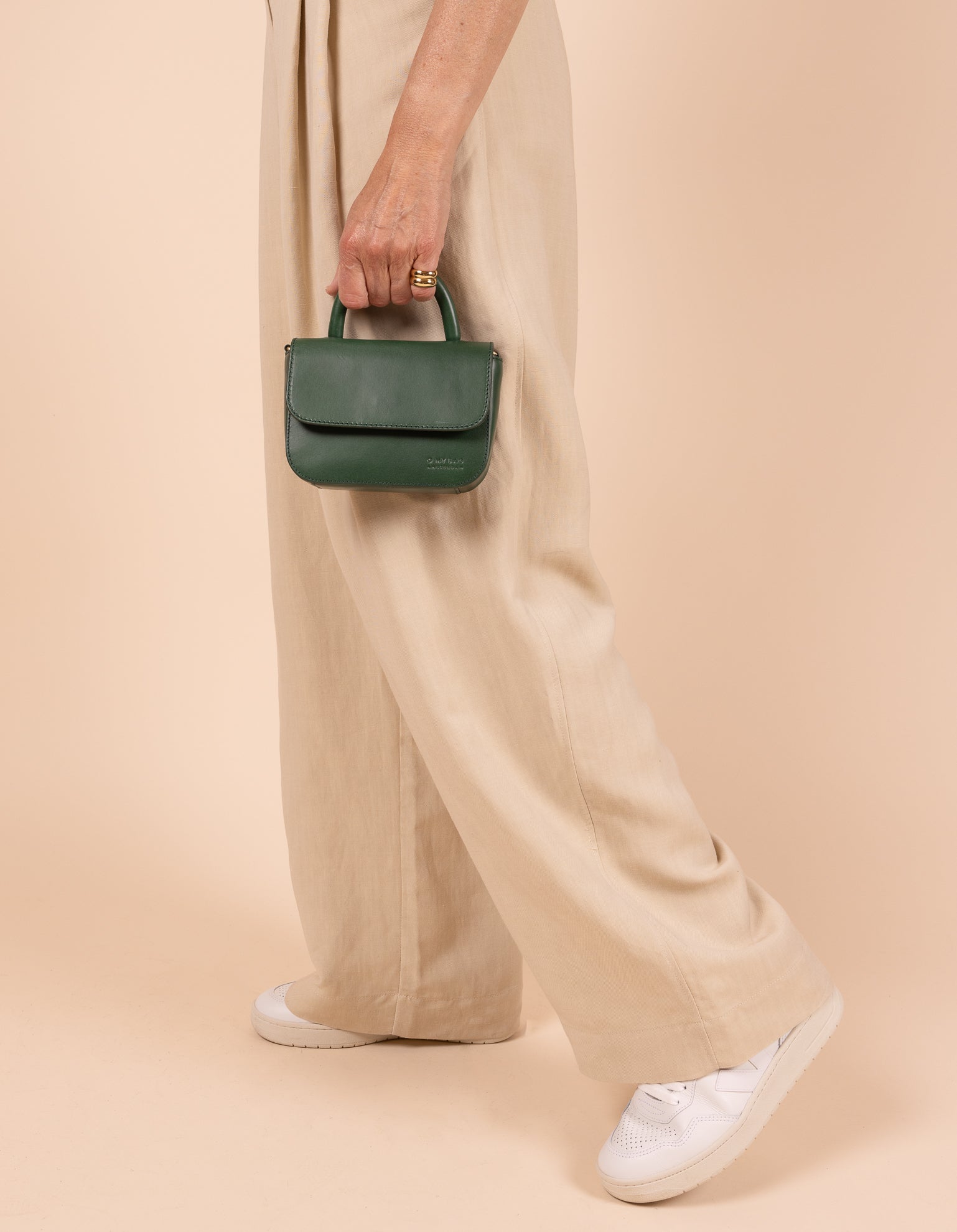 Model image showcasing Audrey Mini pine green classic leather crossbody bag