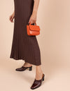 Model image showcasing Audrey Mini tangerine classic leather crossbody bag