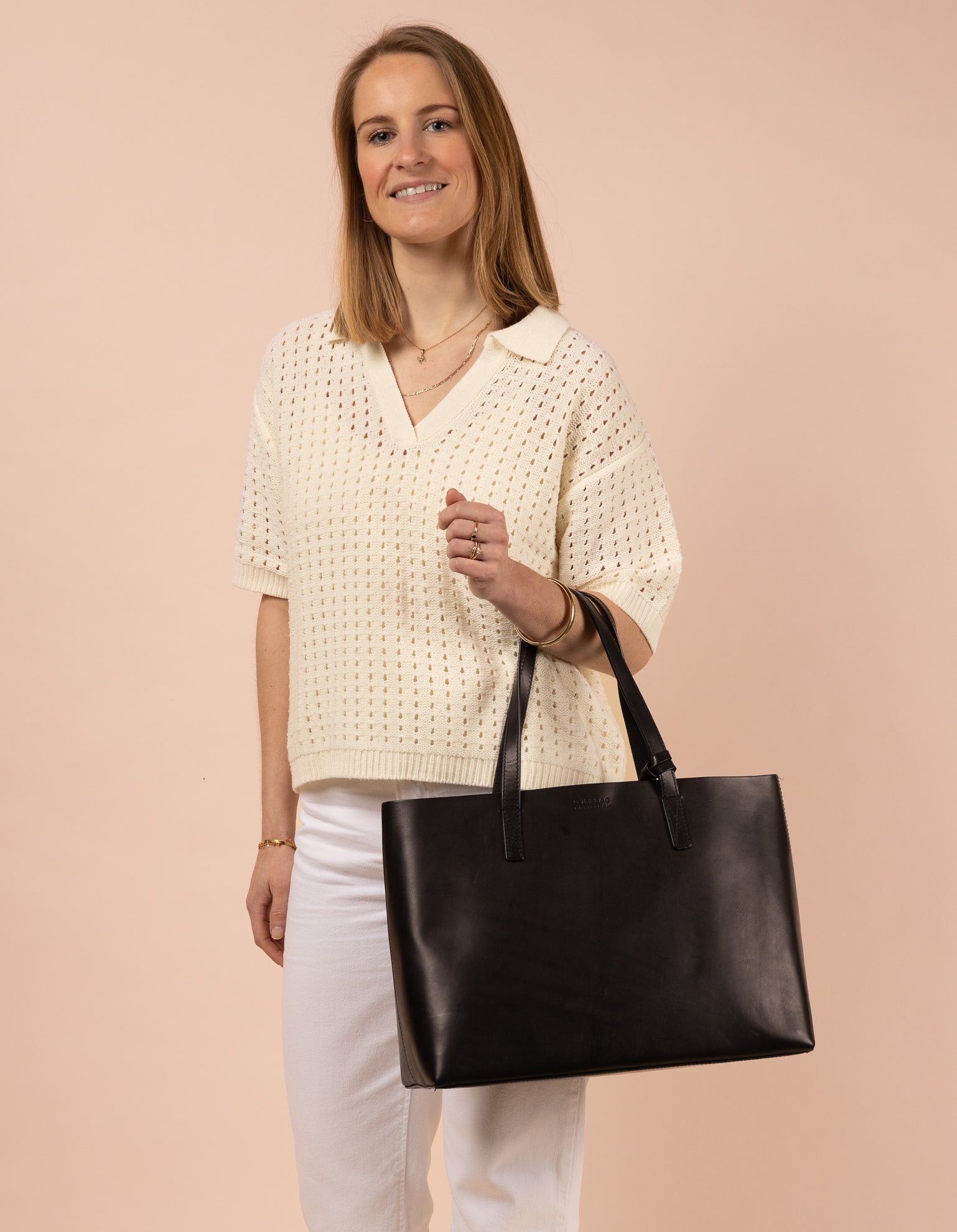 Black leather angled tote bag with model