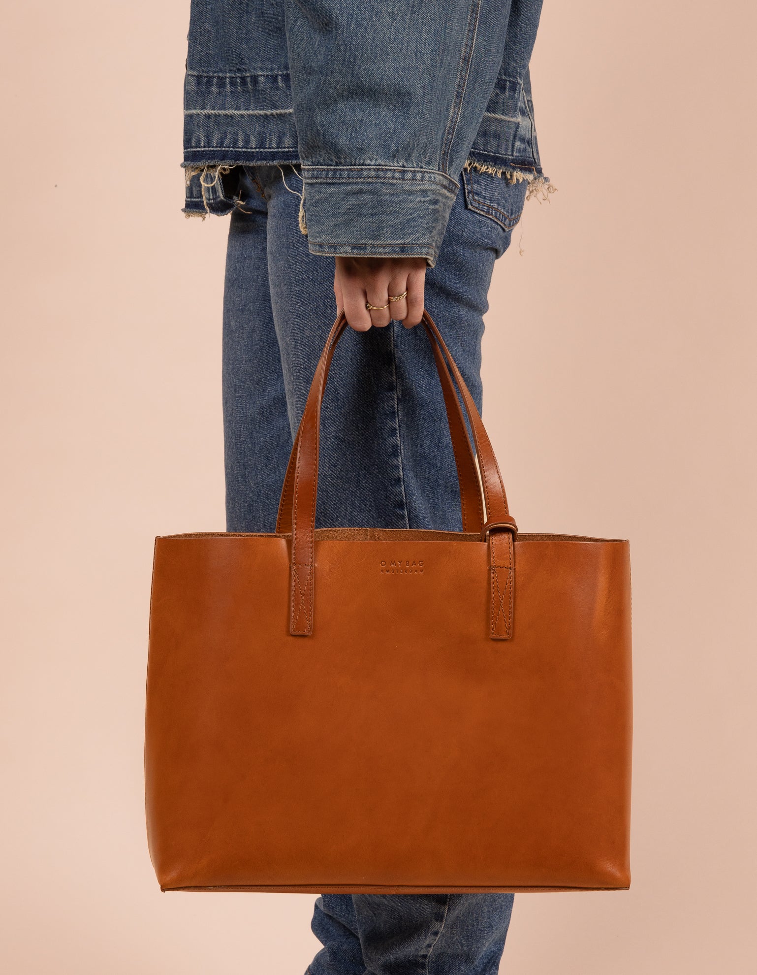 Brown leather angled tote bag with model