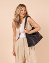 Model image showcasing Sienna black soft grain leather crossbody work bag with braided shoulder strap