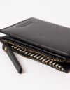 black wallet layed down on white background - close up of zipper handle