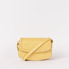 Front view of Kendalini in Butter Yellow-coloured leather with strap