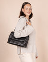 Female model with woven Kenzie bag on shoulder