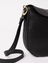 black bag on white background - close up of black classic leather strap hooked on the bag