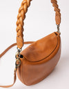 cognac bag on white background - photo of braided and classic leather cognac straps hooked on the bag