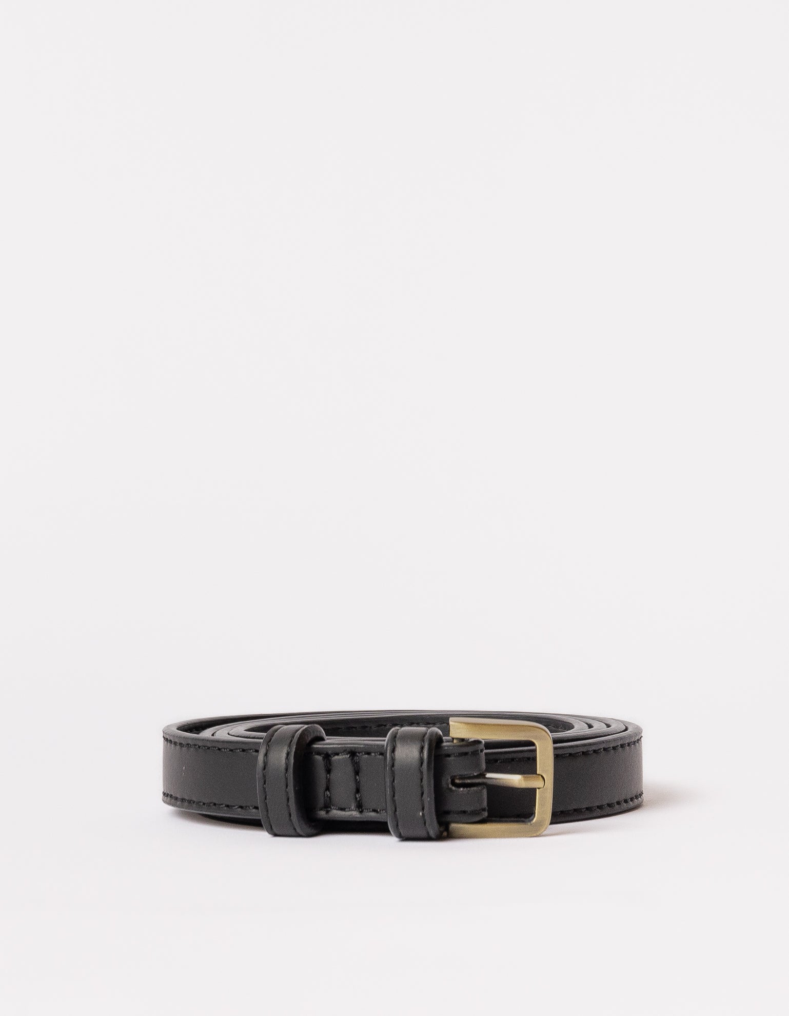 Rolled black belt strap with buckle on white background