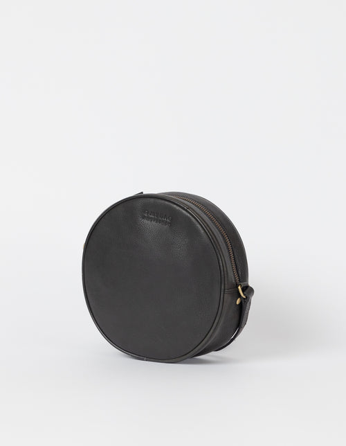 Luna Bag Black Soft Grain Leather. Circular crossbody bag for women. Side product image.