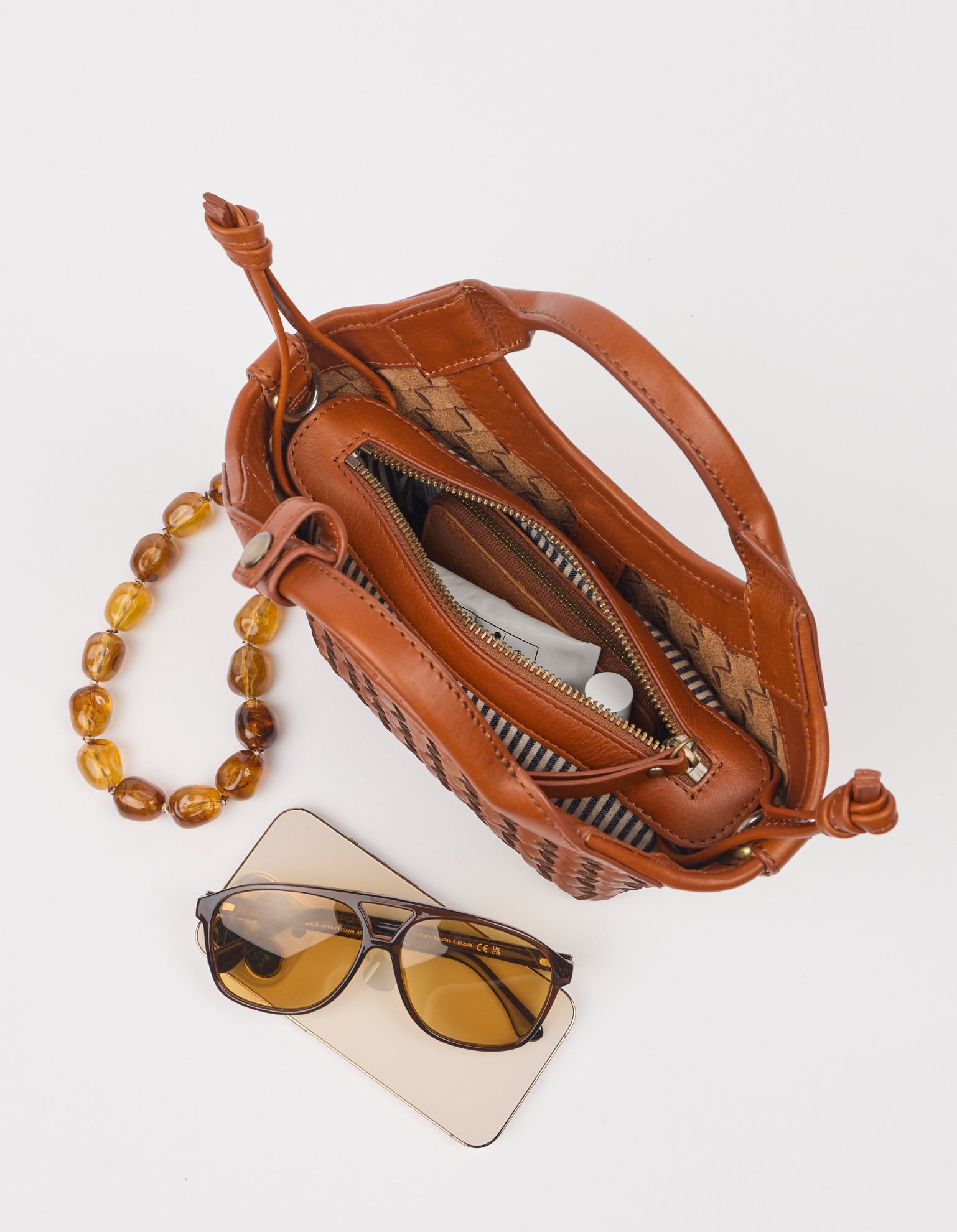 brown leather bag open with products