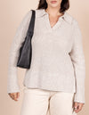 Female model with Nora bag in black soft grain leather on her shoulder