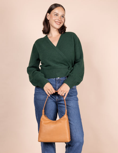 Female model holding Nora bag in wild oak soft grain leather 