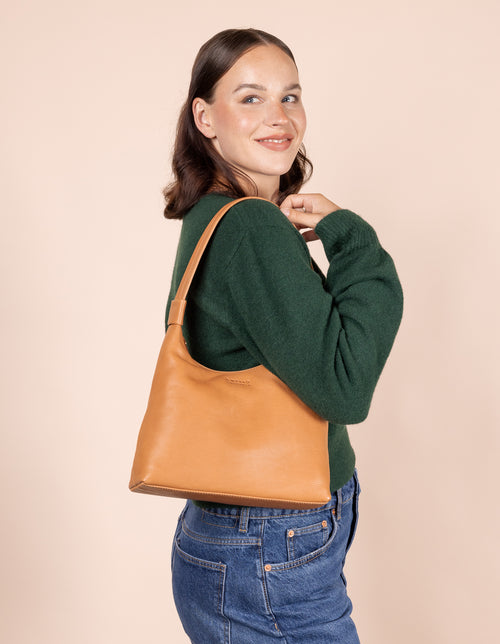 Female model with Nora bag in wild oak soft grain leather on her shoulder